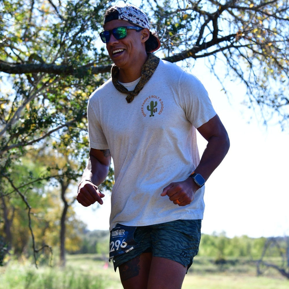 Person running outdoors with trees and grass in the background